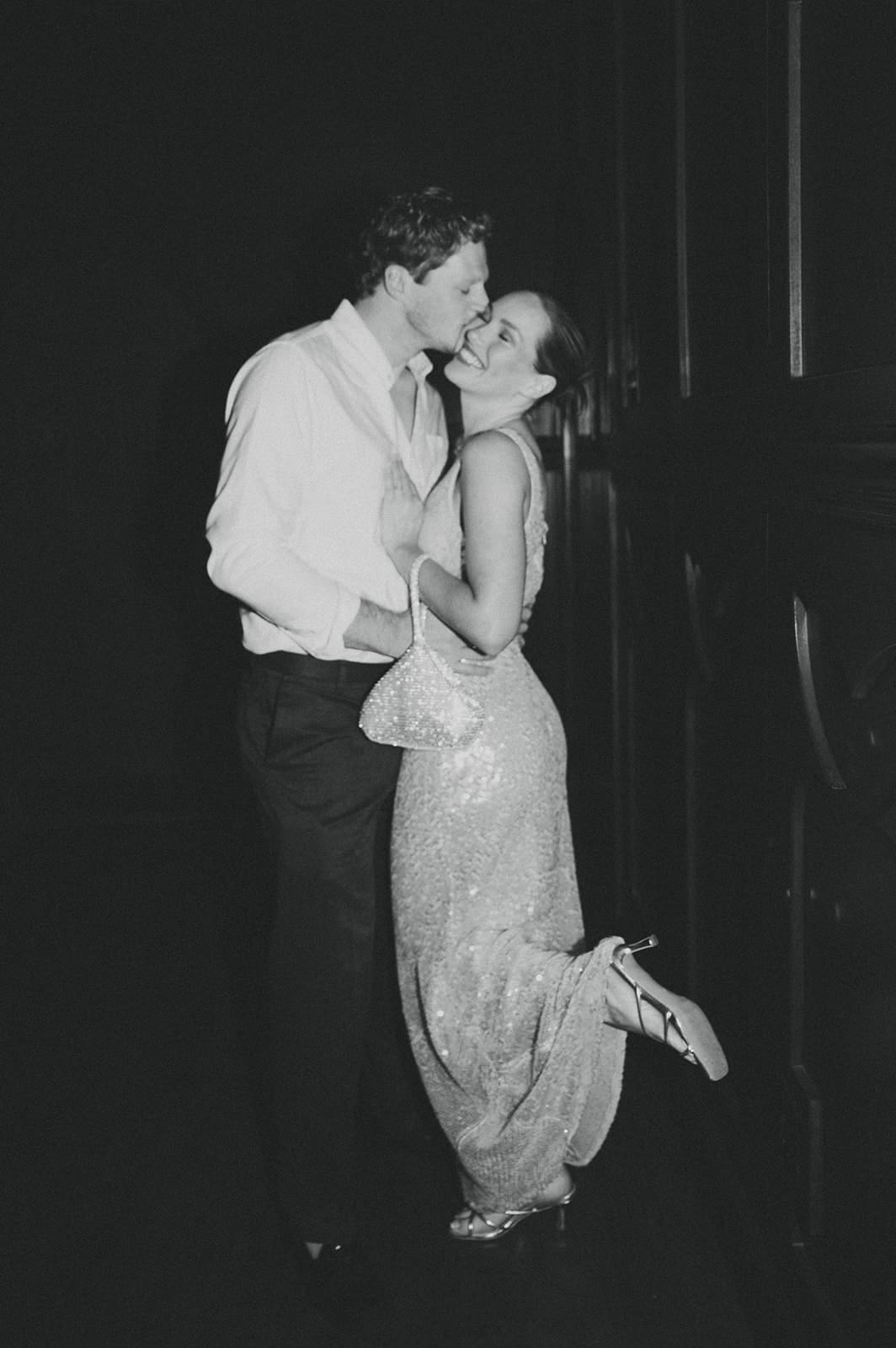 guy kissing fiance's cheek at broadway bar rehearsal dinner